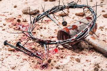 Crown of thorns, hammer, bloody nails on ground. Good Friday, Passion of Jesus Christ. Christian Easter holiday. Top view, copy space. Crucifixion, resurrection of Jesus Christ. Gospel, salvation