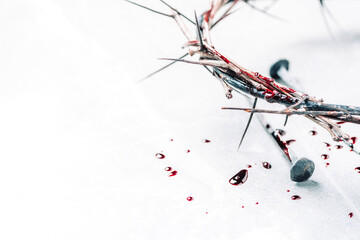 Crown of thorns with blood dripping, nails on stone. Christian concept of Jesus Christ suffering,...