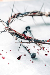 Crown of thorns with blood dripping, nails on stone. Christian concept of Jesus Christ suffering,...