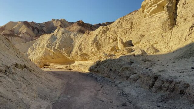 Walking at sunset at Golden Canyon at Death Valley National Park, CA, USA. Moving forward. Tracking