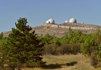 White round radar domes on a hill on the AI-Petri plateau in the mountains of Crimea