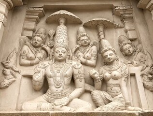 Ancient sandstone carved historical Hindu God sculptures in the temple walls. Carved idols in...