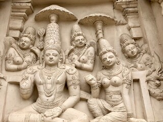 Ancient sandstone carved historical Hindu God sculptures in the temple walls. Carved idols in ancient Kanchi Kailasanathar temple in Kanchipuram, Tamilnadu.