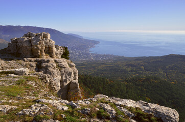 Fototapeta na wymiar Rocks in the morning light on the mountain. The black sea, silvery clouds, the coast of Yalta