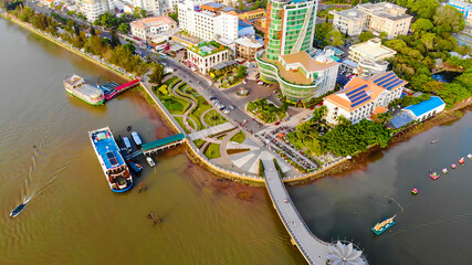 Obraz premium Top view aerial view love bridge or Ninh Kieu quay of downtown in Can Tho City, Vietnam with development buildings, transportation, energy power infrastructure