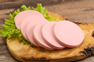 Sliced sausage snak over board © Andrei Starostin