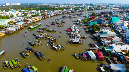Aerial view of Cai Rang floating market, Can Tho, Vietnam. Cai Rang is famous market in mekong delta, Vietnam. Tourists, people buy and sell food, vegetable, fruits on boat, ship
