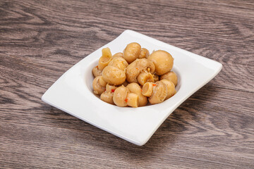 Pickled champignons in the bowl