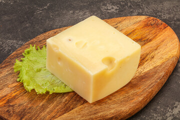 Emmental cheese over wooden board