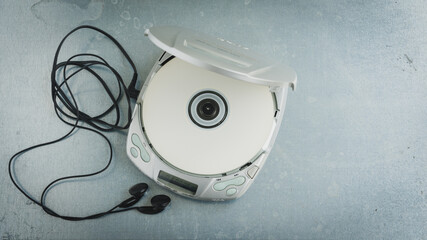 Close up of a vintage portable compact disc player on metal background. - obrazy, fototapety, plakaty