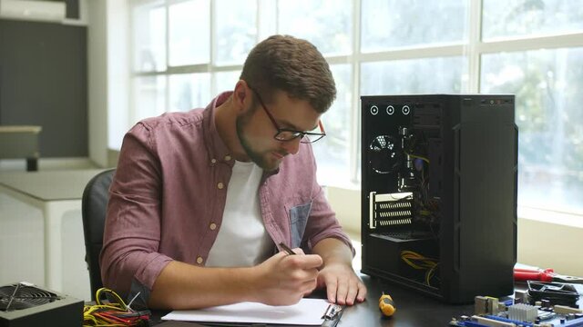 Technician repairing computer in service center