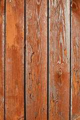 Fototapeta premium Grunge wooden background with texture, old rough boards with orange-brown peeling and cracked old paint