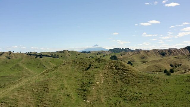 Volcano View Over Small Grassy Hills -  Dramatic Drone Aerial Footage With Lord Of The Rings Scenery - Mount Taranaki, Egmont National Park, New Zealand In 4k