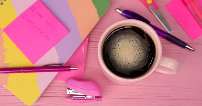 Woman putting cup of hot coffee on table