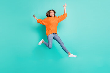 Fototapeta na wymiar Full size photo of young pretty funky funny careless carefree girl with brown hair jumping isolated on turquoise color background