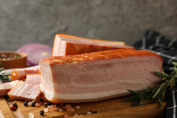 Concept of tasty snack with bacon on wooden board, close up