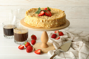 Concept of tasty lunch with stand with Napoleon cake with strawberry