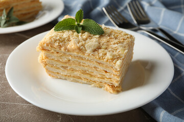 Concept of tasty lunch with Napoleon cake on gray table