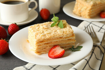 Concept of tasty lunch with Napoleon cake on gray wooden background
