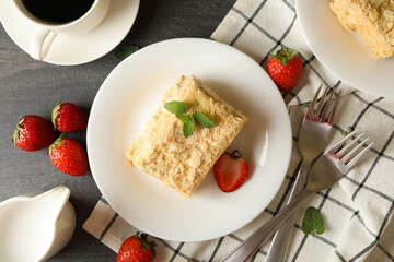Concept of tasty lunch with Napoleon cake on gray wooden background