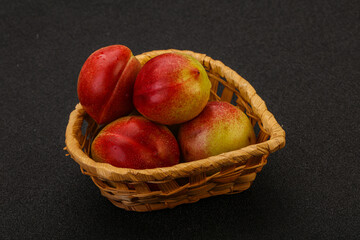 Sweet small nectarines in the basket