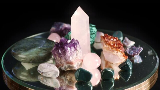 Set of colorful semi-precious stones spinning on a black background
