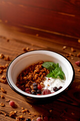 Food photo of fresh and tasty bowl with granola, berries and mint