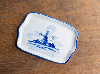 Miniature porcelain tray with Delf style pattern on a wooden table