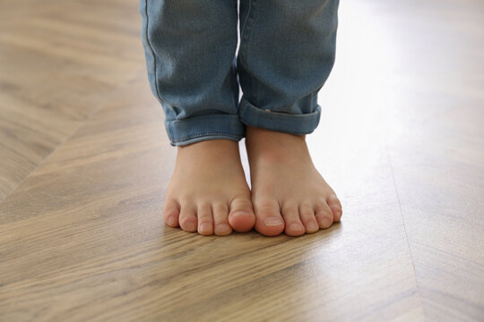 Little Child Walking Barefoot At Home, Closeup. Floor Heating Concept