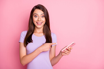 Photo of amazed young girl brown hair hold telephone show pointing gesture dressed casual outfit...