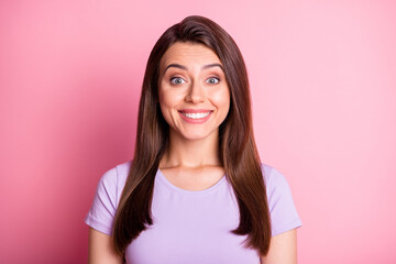 Fototapeta premium Photo portrait of beautiful brunette wearing purple casual t-shirt smiling happily isolated on pastel pink color background