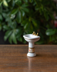 Obraz na płótnie Canvas Miniature washbasin with copper tap - porcelain furniture for a doll house