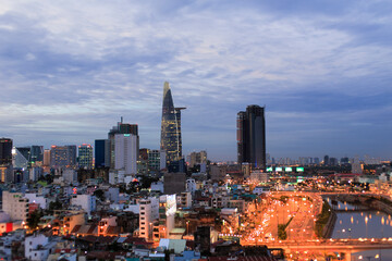 Obraz premium Beautiful night city, cityscape of Ho Chi Minh city, Vietnam, modern futuristic architecture nighttime illumination, luxury traveling concept.