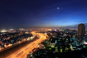 Fototapeta na wymiar Beautiful night city, cityscape of Ho Chi Minh city, Vietnam, modern futuristic architecture nighttime illumination, luxury traveling concept.