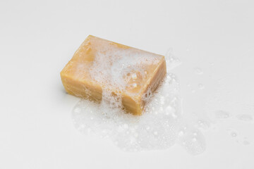 Soap bar and foam on white background, top view. Mockup for design