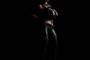 Fototapeta na wymiar Mistress in shiny black latex costume and leather straps