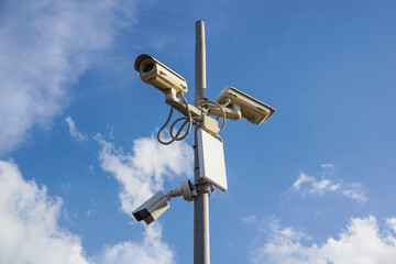 Fototapeta na wymiar Security cctv cameras in front of blue sky