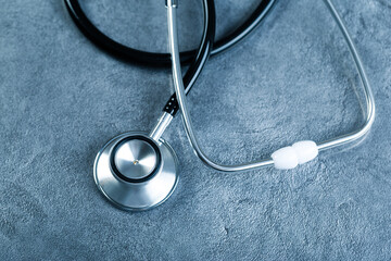 black stethoscope for medical examination on medical laboratory health table background