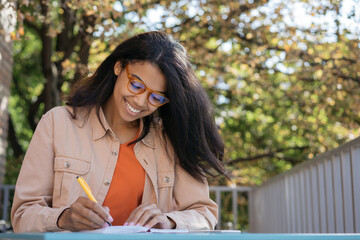 Smiling student studying, learning languages, writing, education concept