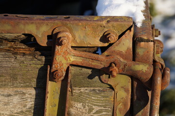 a fragment of an old rusty iron mount along with old rusty bolts
