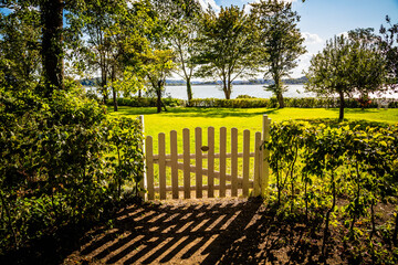 View through a gate to the Schlei estuary, Schleswig-Holstein, Germany