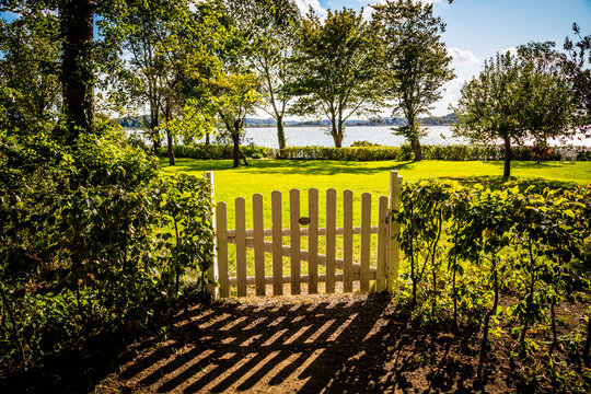 View through a gate to the Schlei estuary, Schleswig-Holstein, Germany