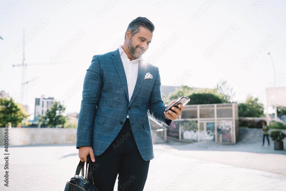 Poster cheerful caucasian businessman 40s using cellular application for checking banking balance, middle a
