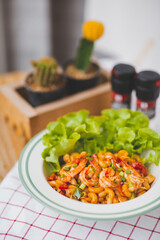 Macaroni, shrimps, Tomato and vegetable Served in White Plates on Table