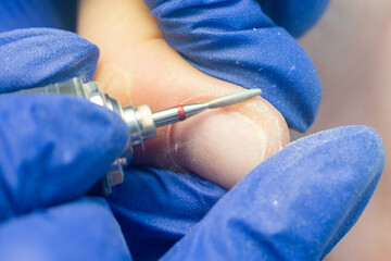 Manicure process, cleaning nails with a milling cutter close up