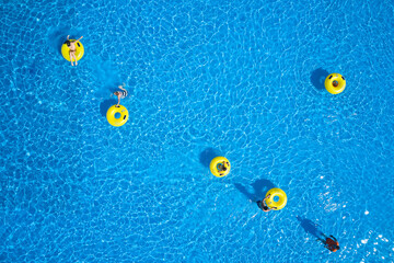 Water park background. Top view - young people relax in swimming pool at bubble bath.