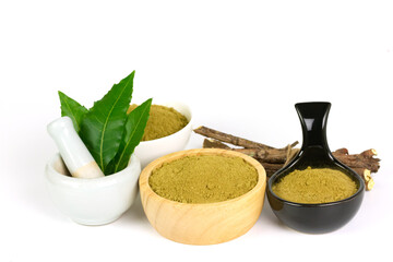 neem powder in wooden black white bowl with neem leaf in white mortar and pestle isolated on white...