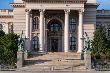 The National Assembly Building of the Republic of Serbia, it is a landmark and tourist attraction. Summer day with blue sky in background. Belgrade, Serbia - 14.07.2020