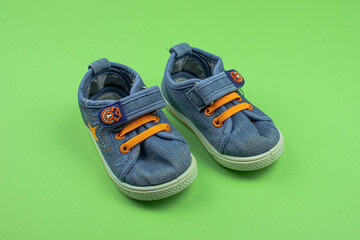 Children's sports shoes. A pair of children's shoes on a green background. Children's sneakers.