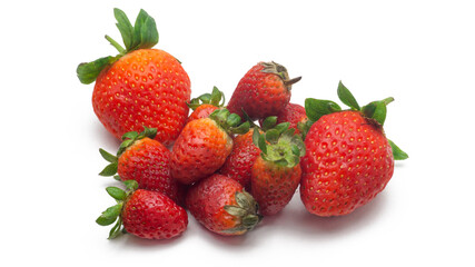 Close up view a group of fresh small and big red strawberries with leaves on isolated white background.